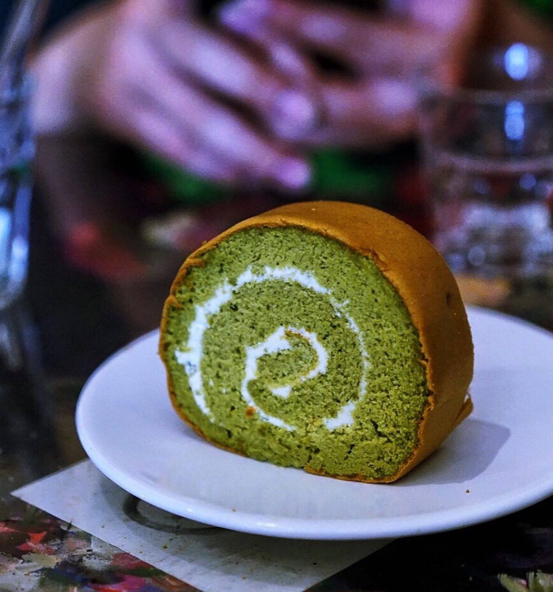 A slice of green tea cake roll on a plate